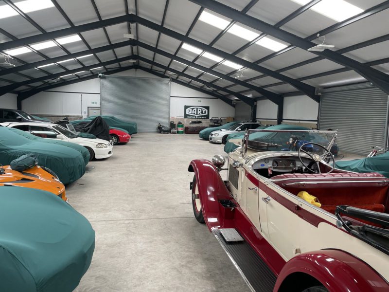 Classic cars in a large storage facility.